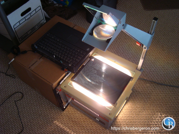 The LCD laying on the projector base with the laptop nearby