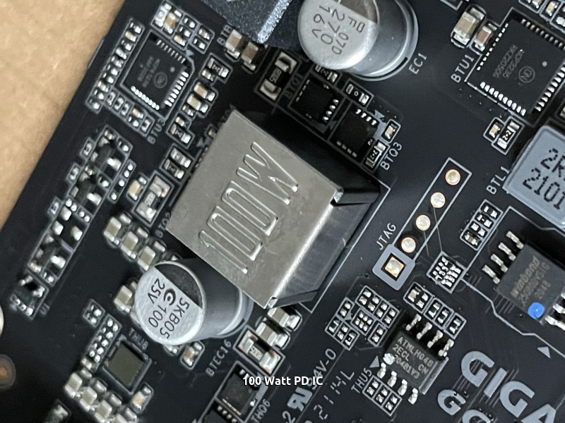 Close up picture of a chip labeled 100W 100 Watt power delivery controller