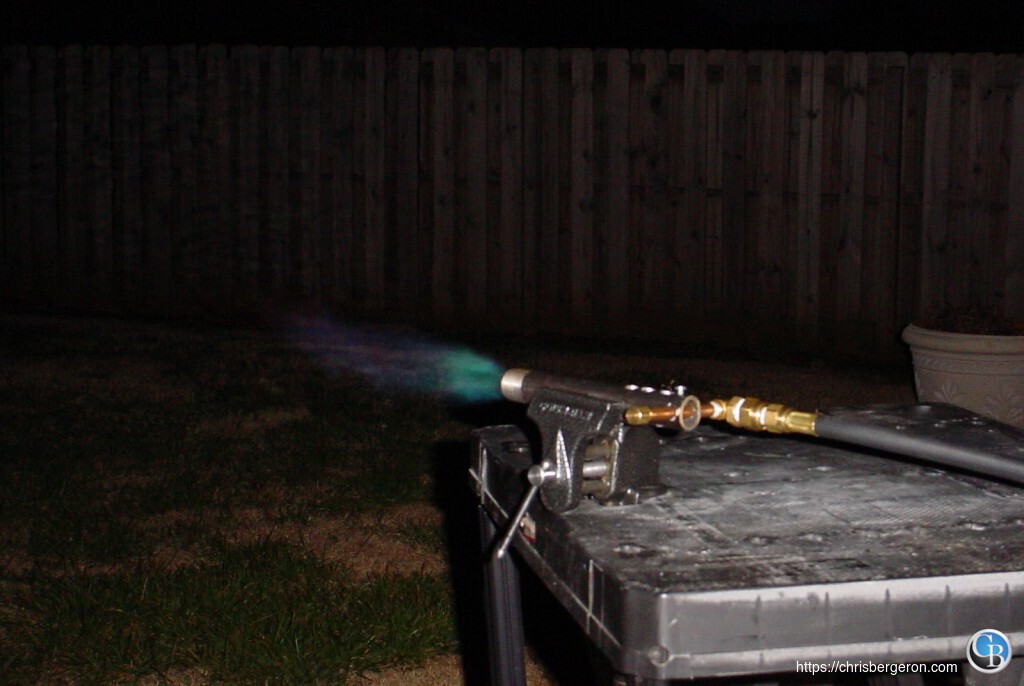 The burner throwing a blue propane flame